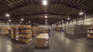 A well-organized and high-paying warehouse with neatly stacked pallets.